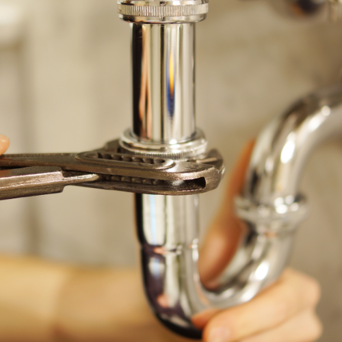 close-up-of-a-chrome-pipe-being-tightened-with-an-adjustable-wrench-during-plumbing-repair - Fix It-Cincy close-up-of-a-chrome-pipe-being-tightened-with-an-adjustable-wrench-during-plumbing-repair