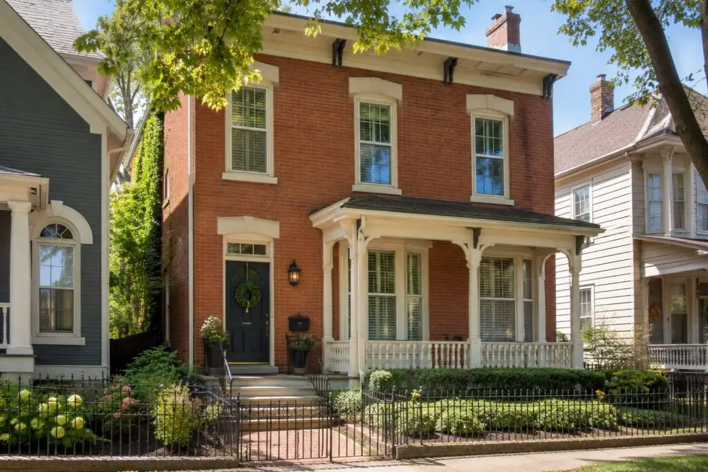 A historic two-story Northern Kentucky home with a covered porch and mature trees