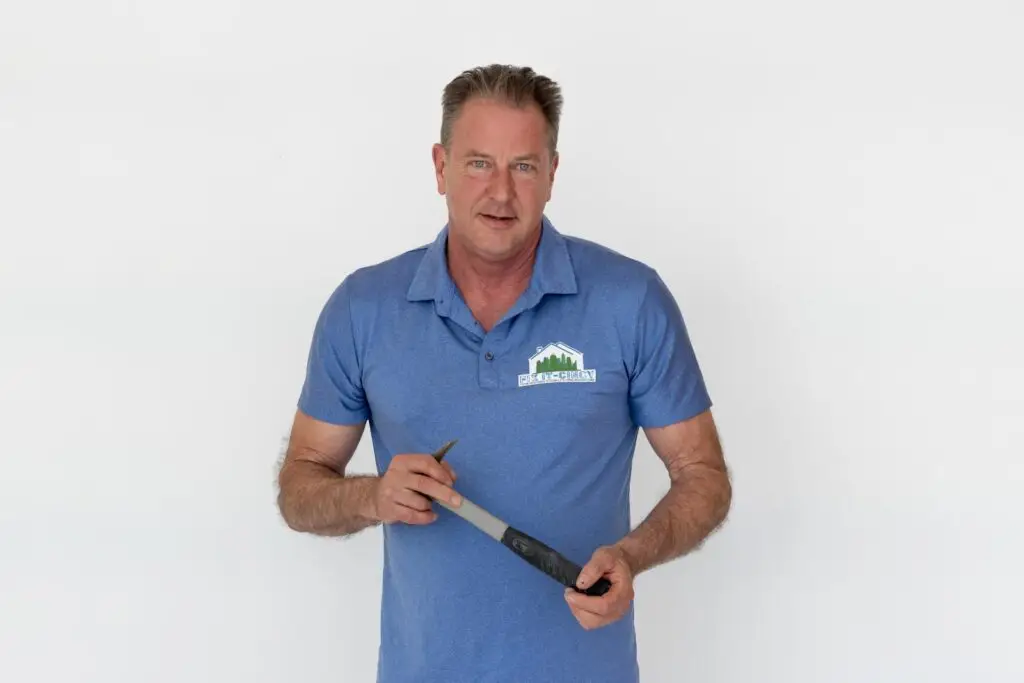Kevin Delaney of Fix It-Cincy holding a hammer, ready for home repairs in Cincinnati