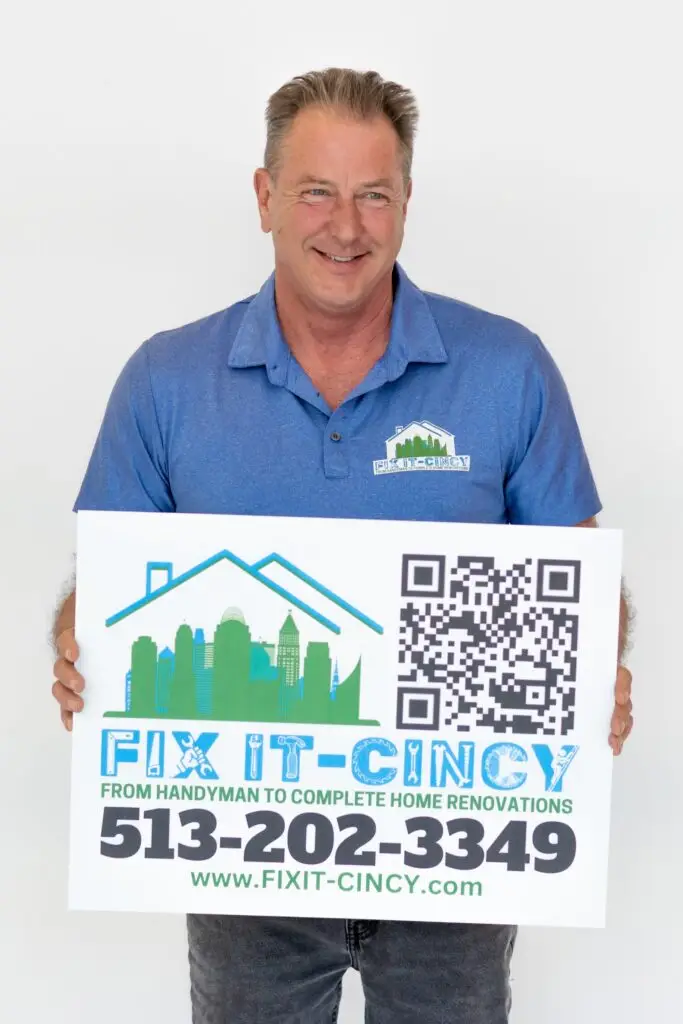 Kevin Delaney holding the Fix It-Cincy sign with phone number (513) 202-3349